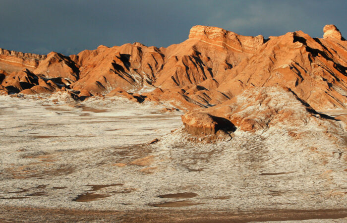 The image shows the reddish hills within the Atacama Desert in CHile.